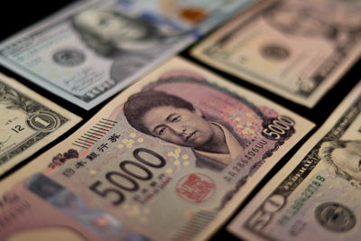 Japanese currency and American dollars. 5000 yen from Japan and some American dollars. Currency from the USA and Japan.