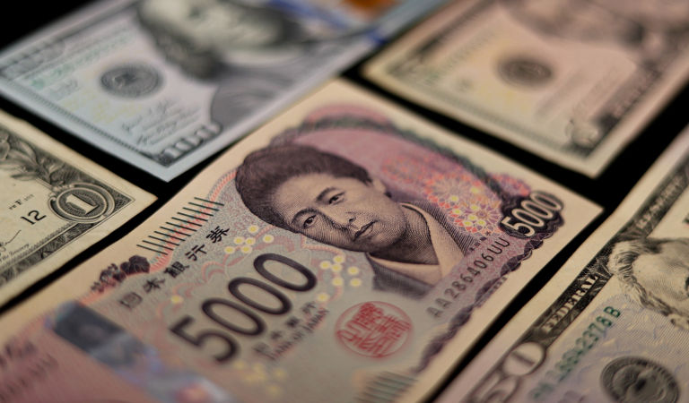 Japanese currency and American dollars. 5000 yen from Japan and some American dollars. Currency from the USA and Japan.