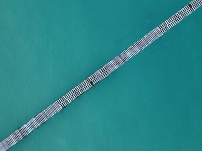 Aerial view of wooden footbridge across ocean