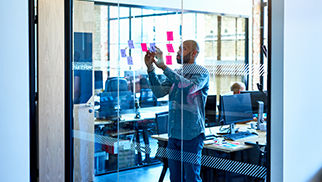 businessman-glass-sticky-notes-1070958790