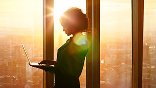 businesswoman-on-laptop-window-550215717