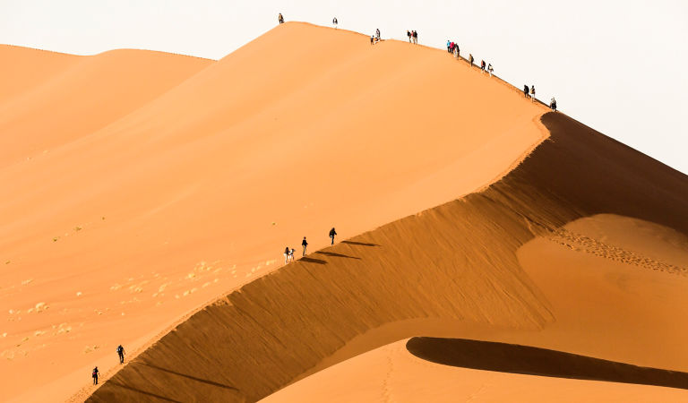 Tourist's climbing a sand dune. Sossusvlei,Namibia.
