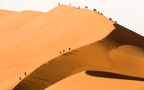 Tourist's climbing a sand dune. Sossusvlei,Namibia.