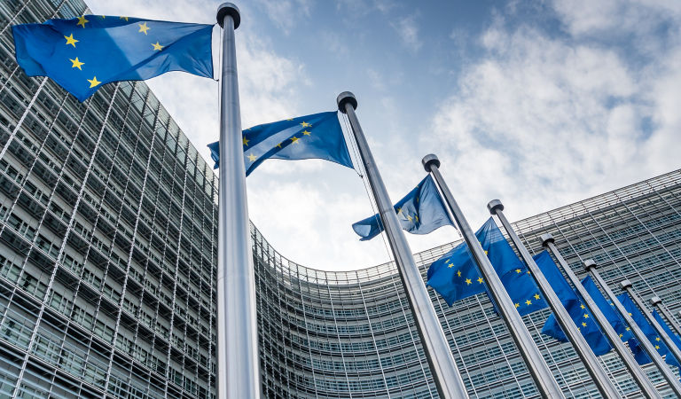 European Union flags waiving at Berlaymont building of the European Commission in Brussels, Belgium