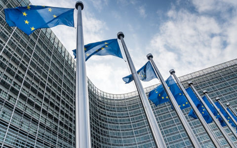 European Union flags waiving at Berlaymont building of the European Commission in Brussels, Belgium