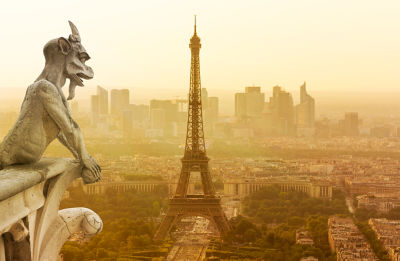 Gargoyle figur on Notre Dame looking towards Eiffel Tower
