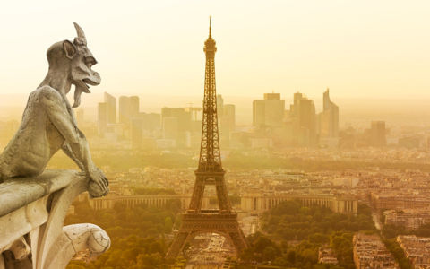 Gargoyle figur on Notre Dame looking towards Eiffel Tower