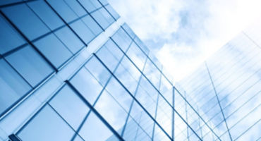 glass building with sky with sun