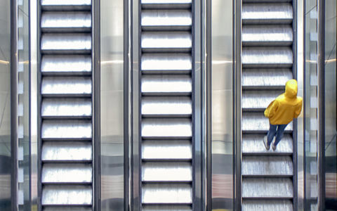 man is going up the escalator