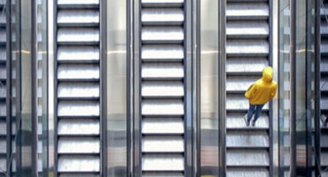 man is going up the escalator