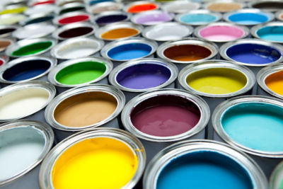 Open paint cans filled with various colors