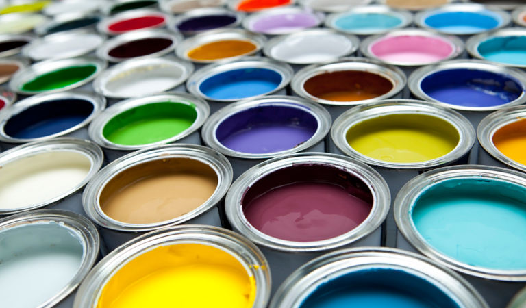 Open paint cans filled with various colors