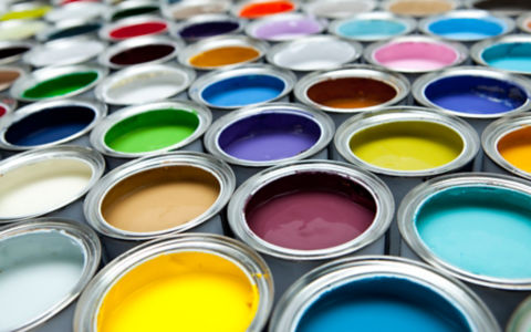 Open paint cans filled with various colors