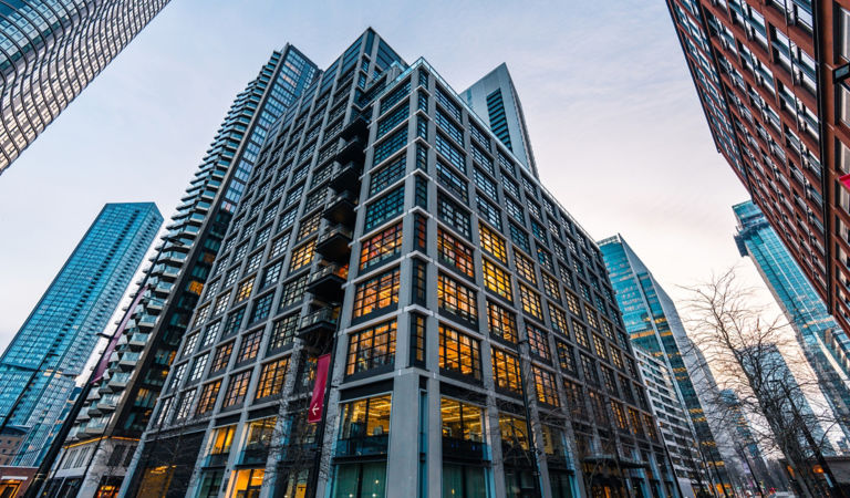Low angle view of modern office buildings at dusk in canary wharf, a major business district in london, uk