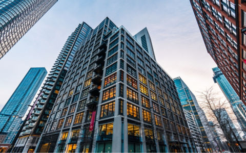 Low angle view of modern office buildings at dusk in canary wharf, a major business district in london, uk