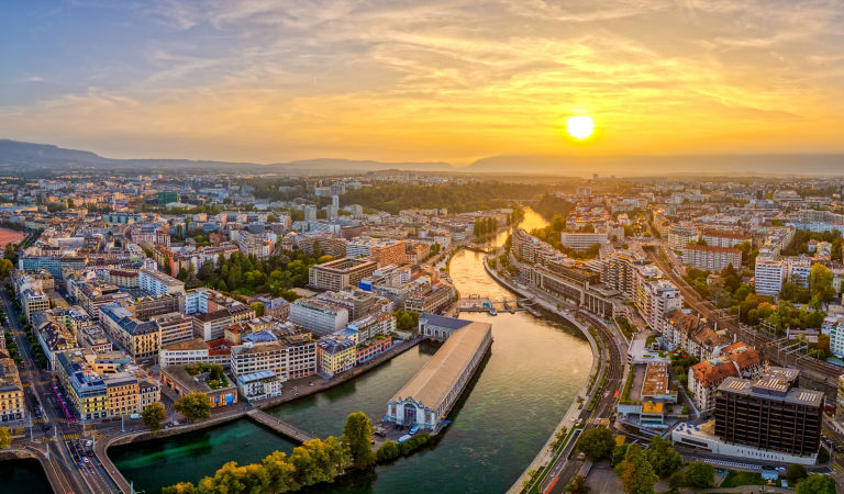 Geneva, Switzerland skyline view over the river at sunset