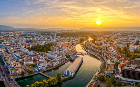 Geneva, Switzerland skyline view over the river at sunset